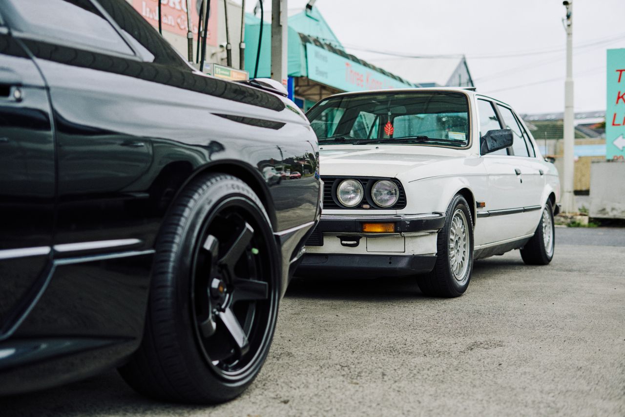 Classic sports cars parked in Auckland, showcasing street culture and car modifications.
