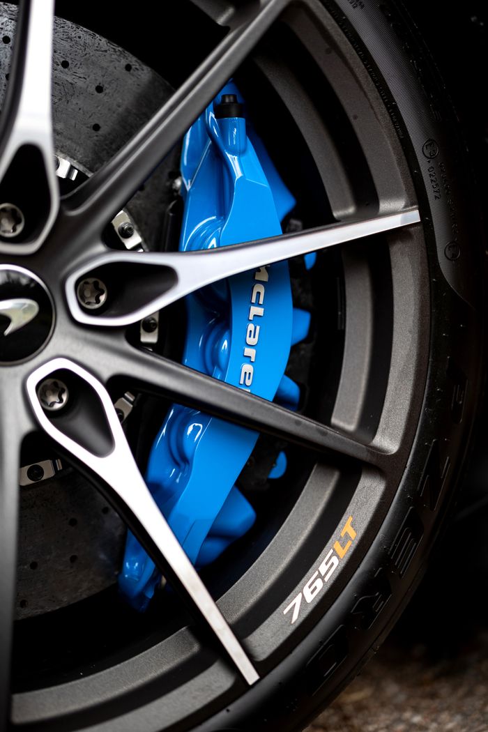 Detailed shot of McLaren 765LT wheel showing blue brake caliper and sleek design in Sydney.